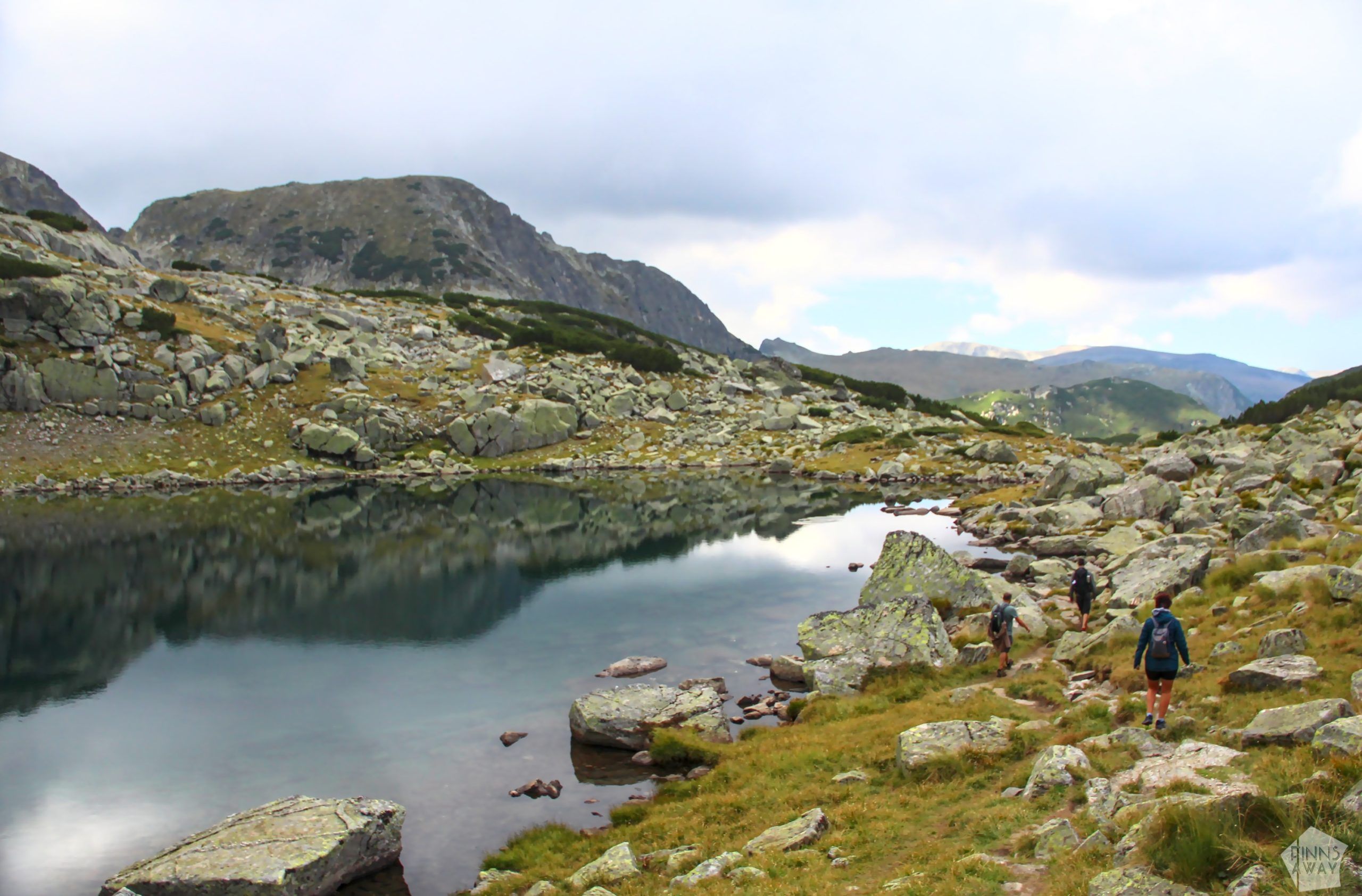 Hikers passing a mountain lake | Hiking in Rila Mountains, Bulgaria | FinnsAway blog